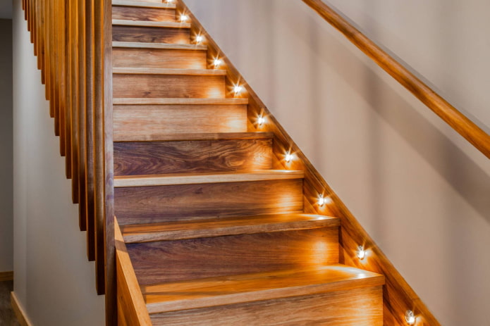 Escalera de madera iluminada en el interior de la casa.