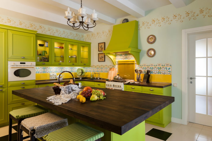 cocina con juego de muebles de color verde claro y delantal amarillo